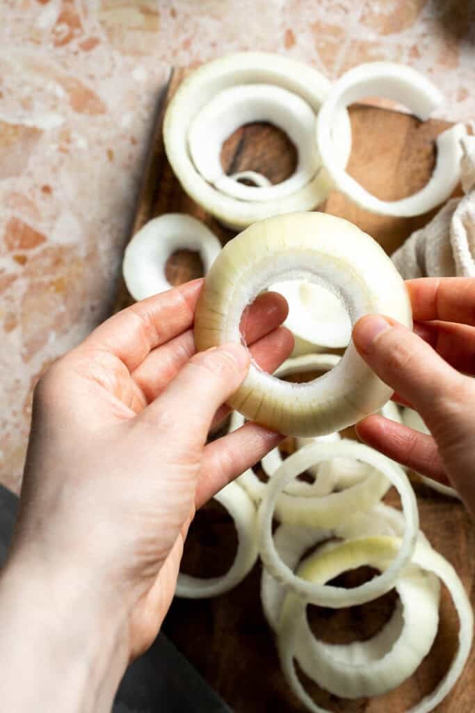 Separating sliced onions into individual onion rings.