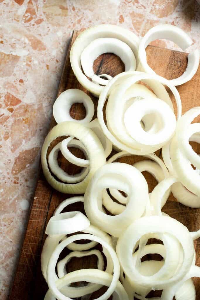 Fresh onion rings on a cutting board.