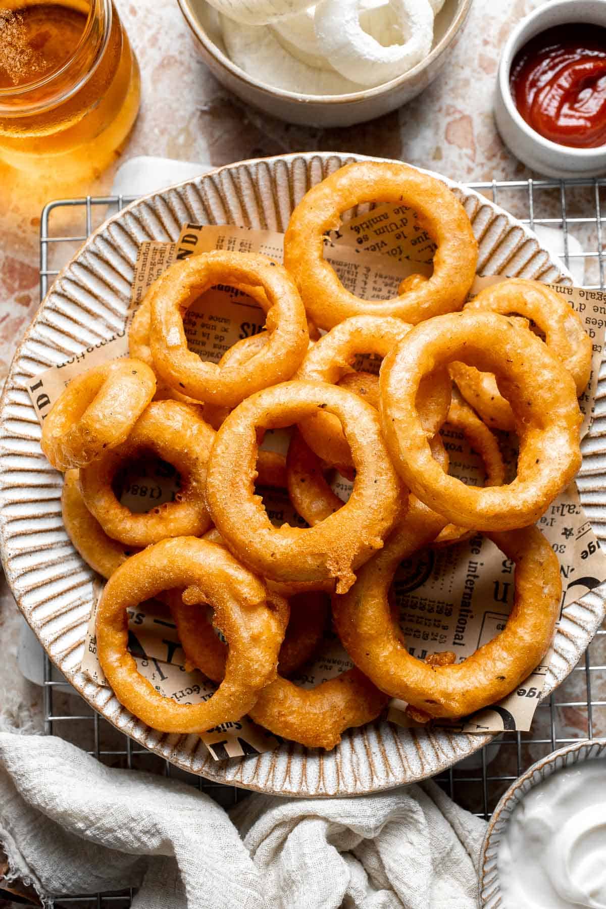 Beer Battered Onion Rings served on a plate with dipping sauces.