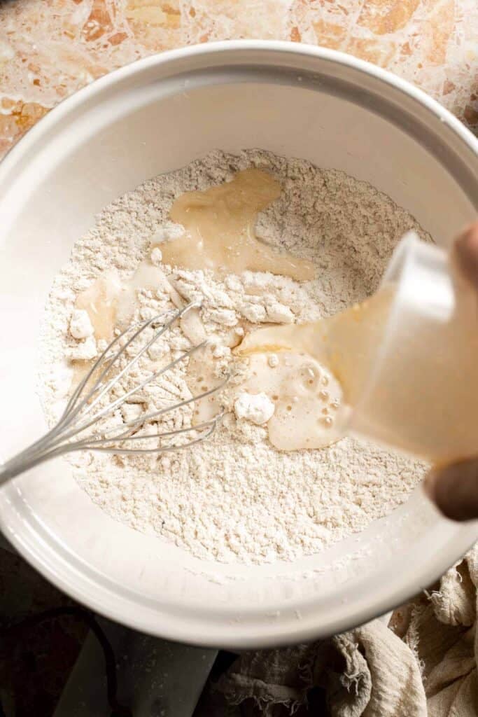 Pouring cold beer into the flour mixture.