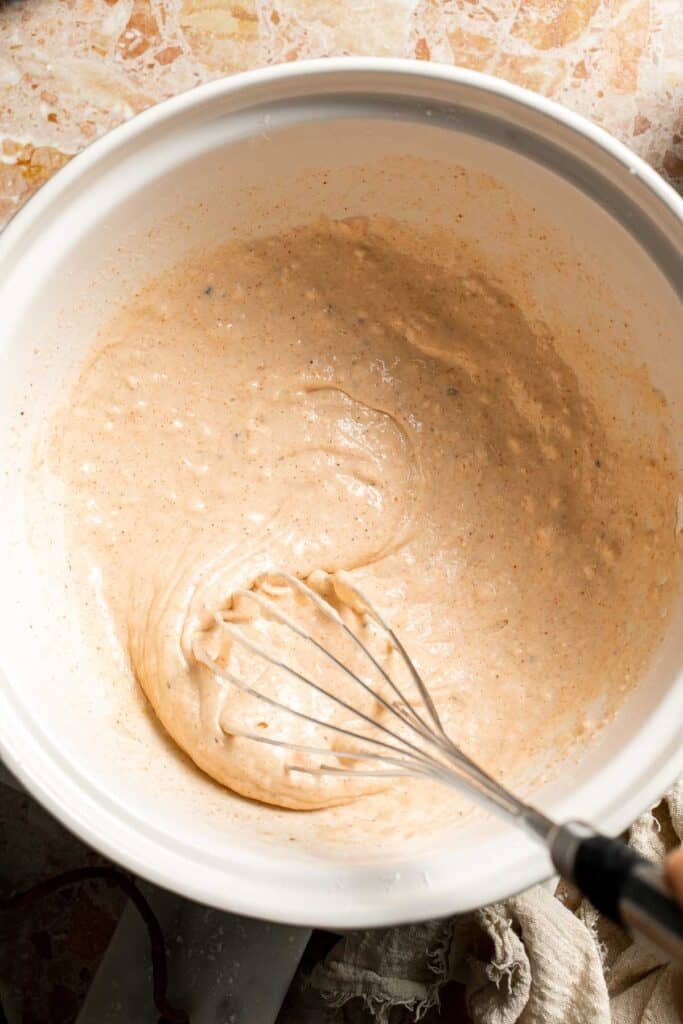 Whisking the beer batter until smooth.