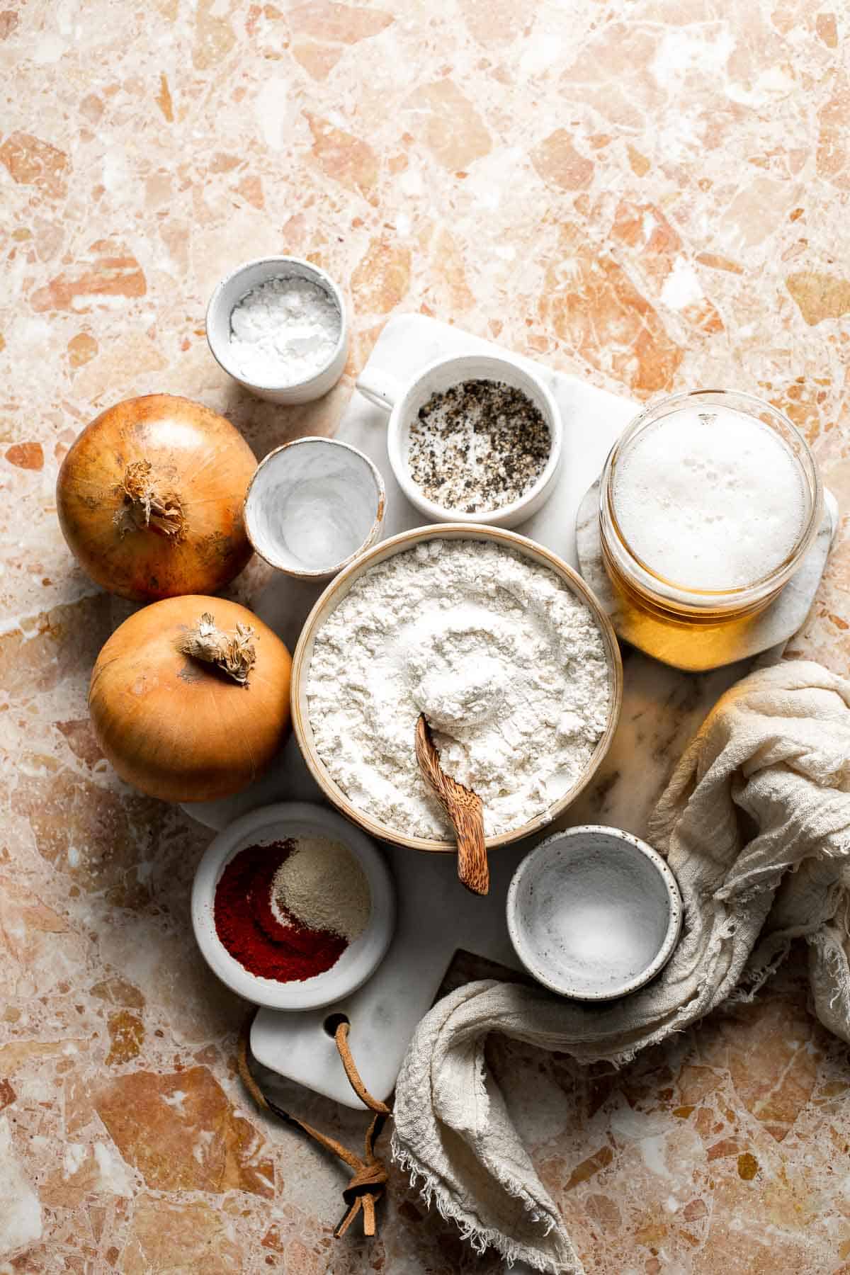 Ingredients for Beer Battered Onion Rings including sweet onions, flour, cornstarch, beer, and seasonings.