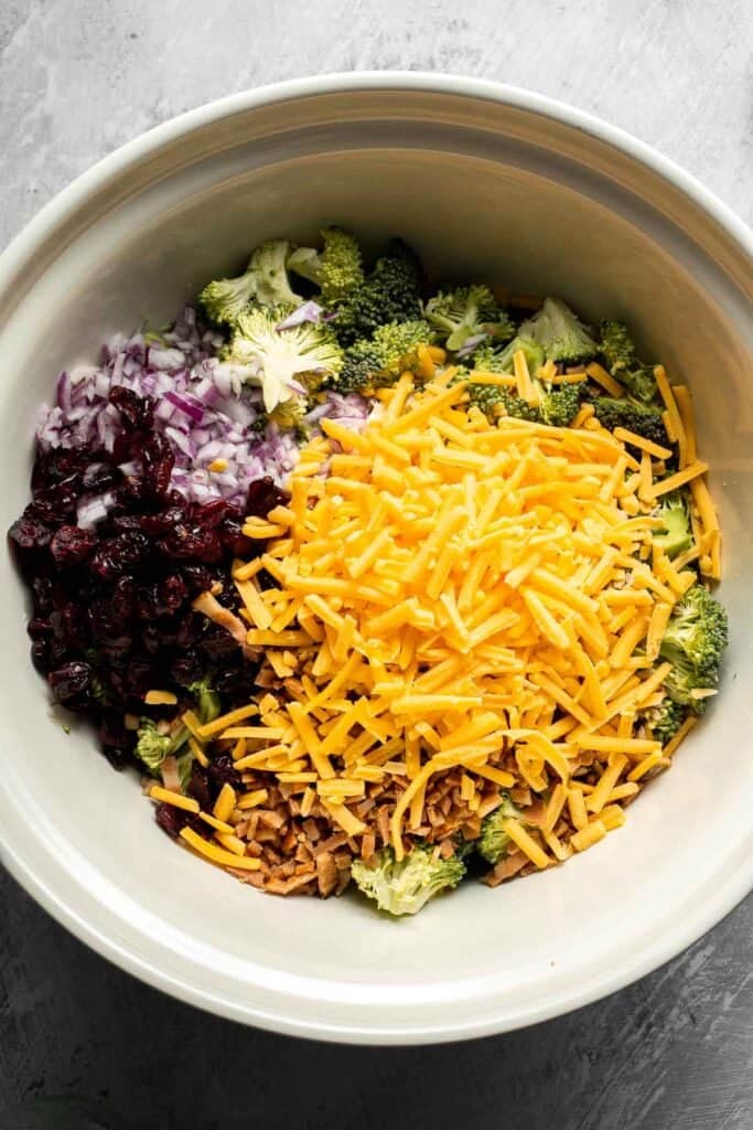 Broccoli salad ingredients combined in a large bowl.