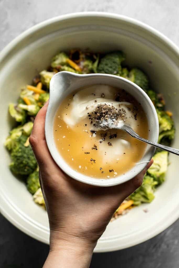 Whisking the broccoli salad dressing together.