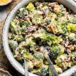 Creamy Broccoli Salad with bacon, cheddar cheese, dried cranberries, sunflower seeds, and a tangy homemade dressing.