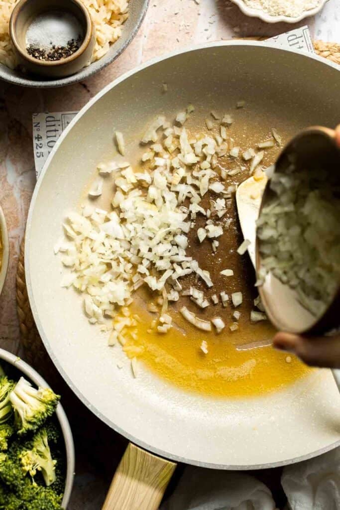Shallot and garlic added to melted butter in a skillet
