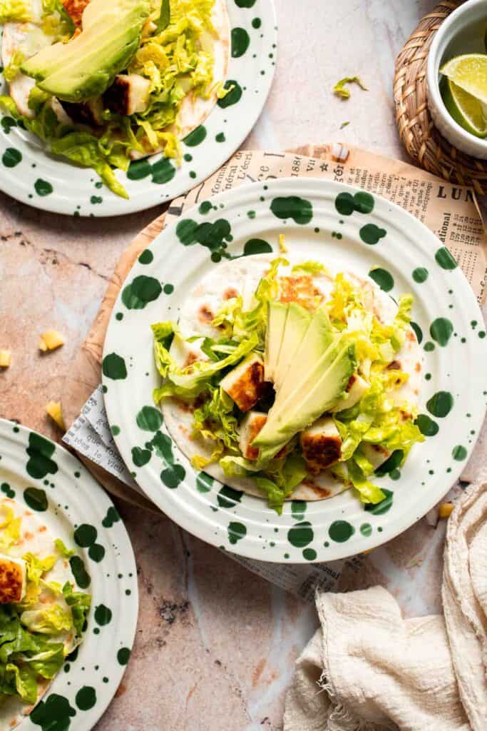 Adding sliced avocado to the taco.