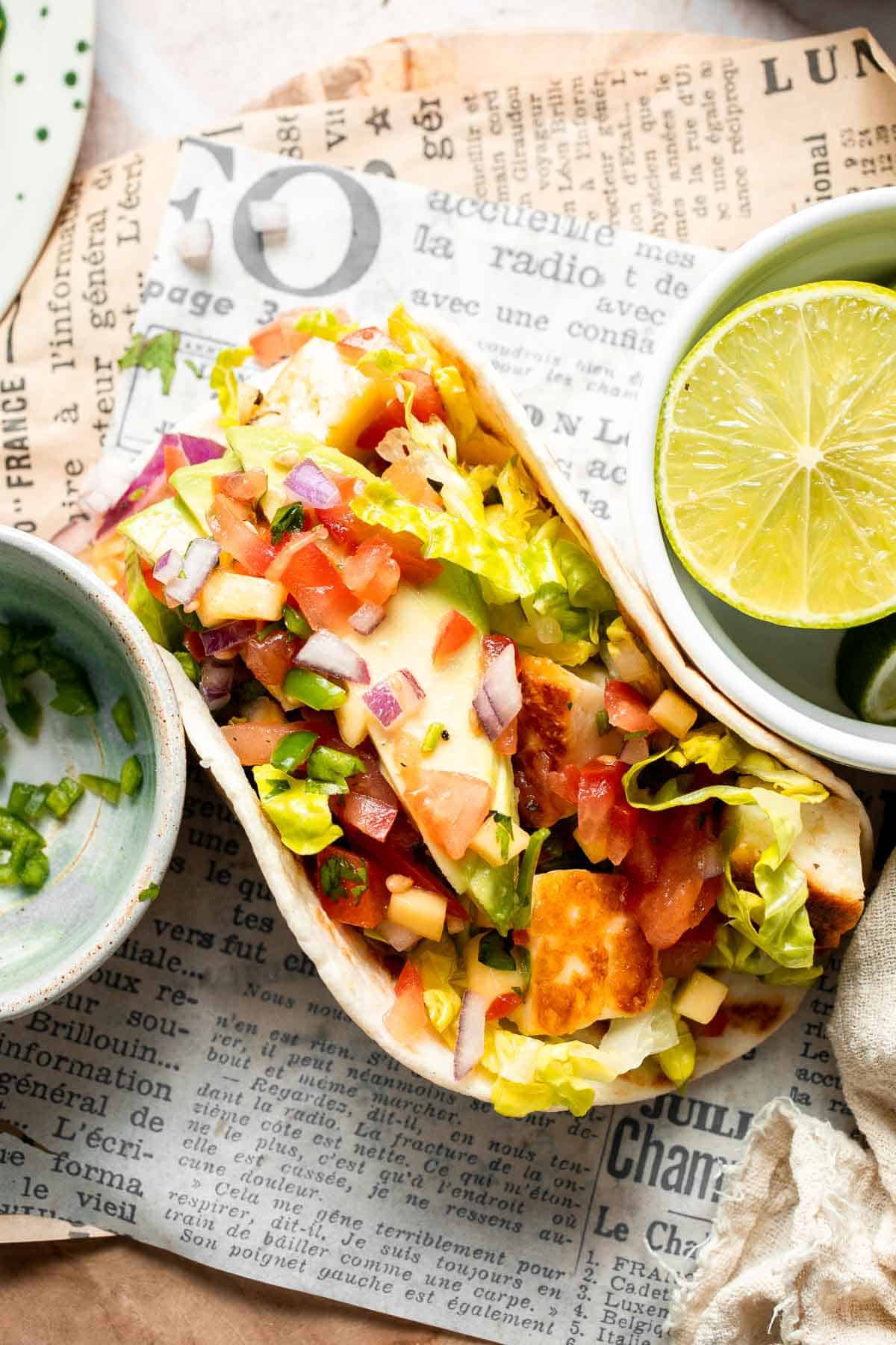Halloumi Taco topped with fresh mango salsa and avocado.