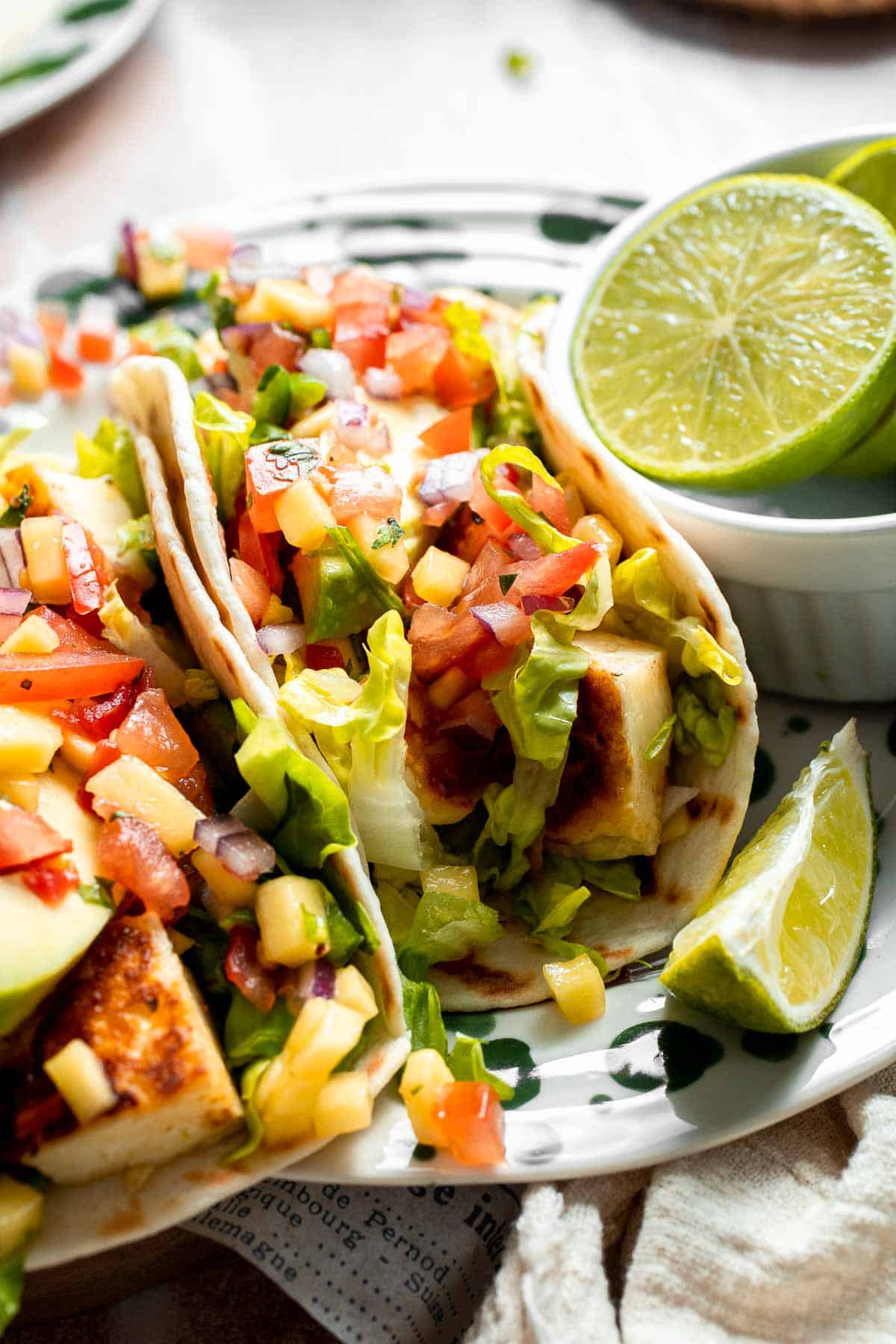 Close-up of a Halloumi Taco with crispy halloumi, avocado, cabbage, and mango salsa.