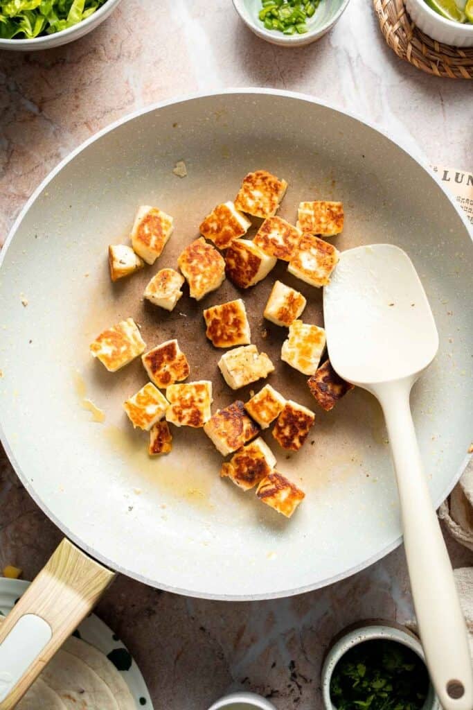 Crispy golden halloumi cubes after pan-frying.