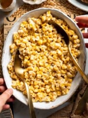 Overhead view of honey butter skillet corn in a serving bowl with a spoon