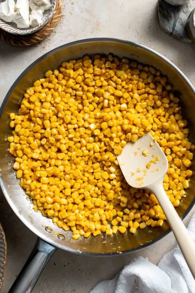 Corn cooking and turning golden in a skillet