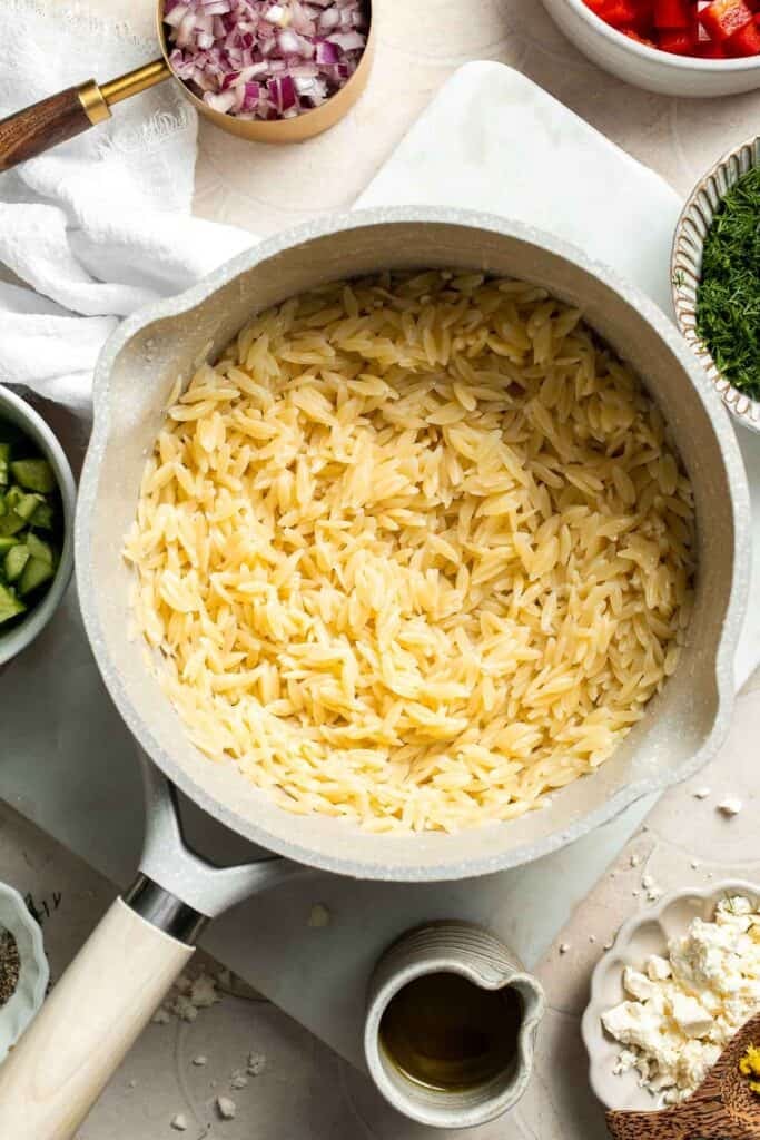 Cooked orzo pasta drained and ready for the salad.