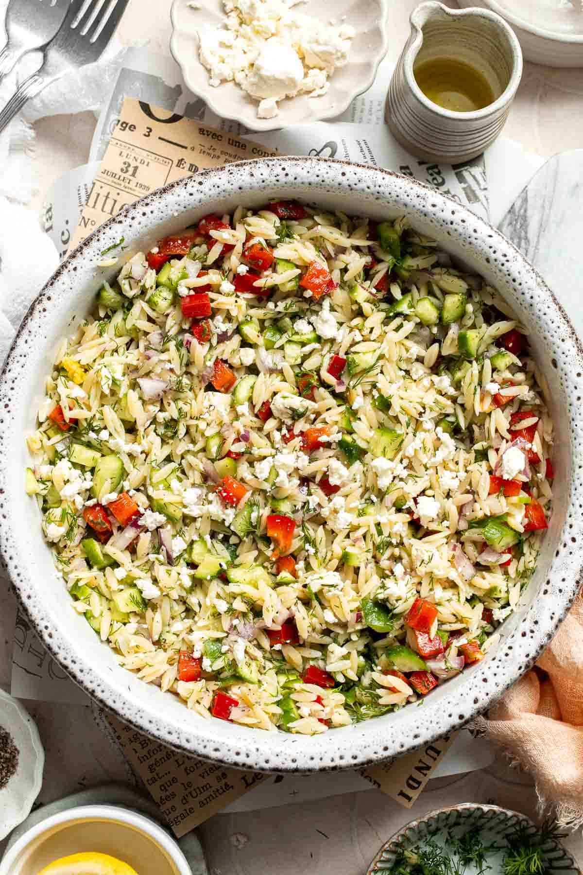 Large bowl of Lemon Orzo Salad garnished with feta and fresh dill.