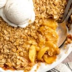 Warm Peach Crisp with juicy baked peaches, a buttery oat topping, and vanilla ice cream.