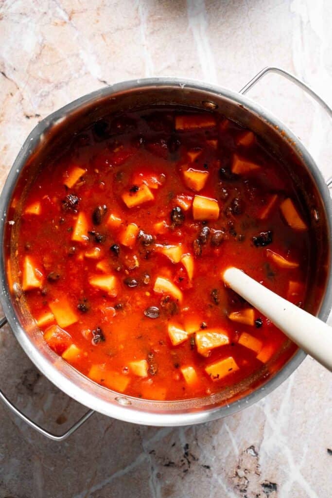 Sweet potato black bean chili simmering in a pot