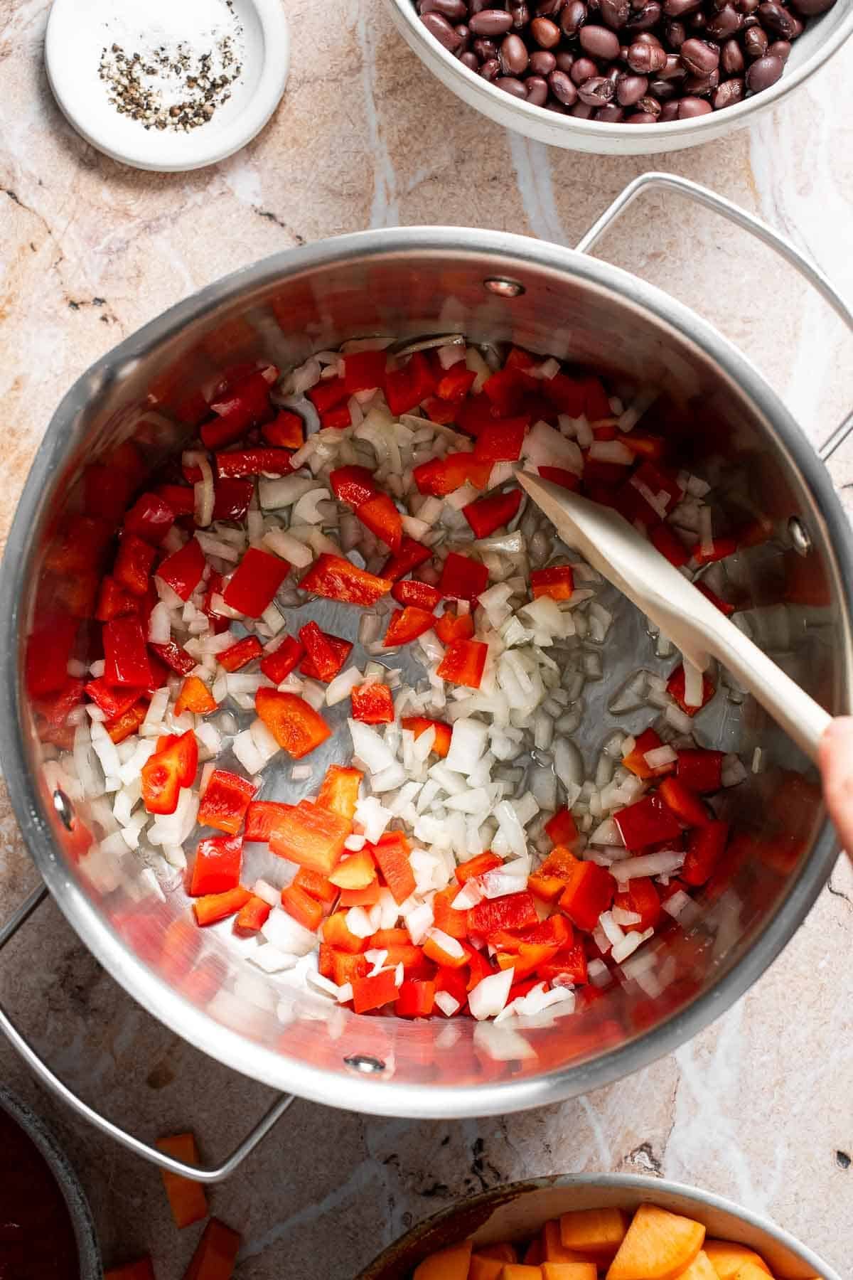 Diced onion and bell pepper cooking in a pot