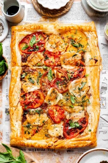 Tomato Puff Pastry Tart with mozzarella, roasted tomatoes, caramelized onions, fresh basil, and flaky golden pastry.