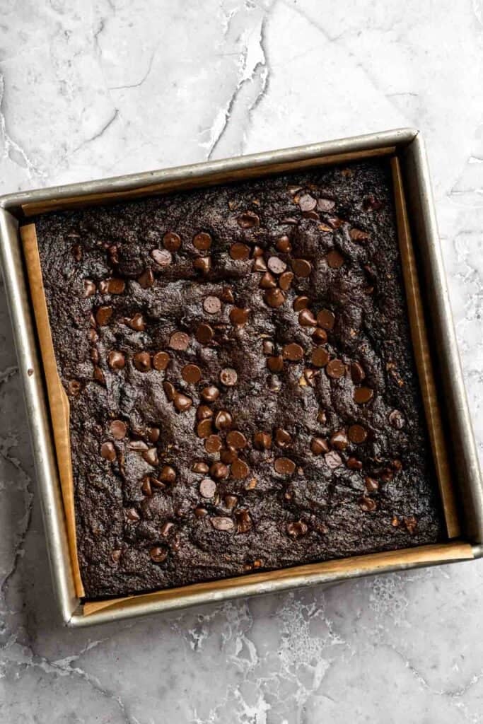 Baked fudgy zucchini brownies cooling in the pan