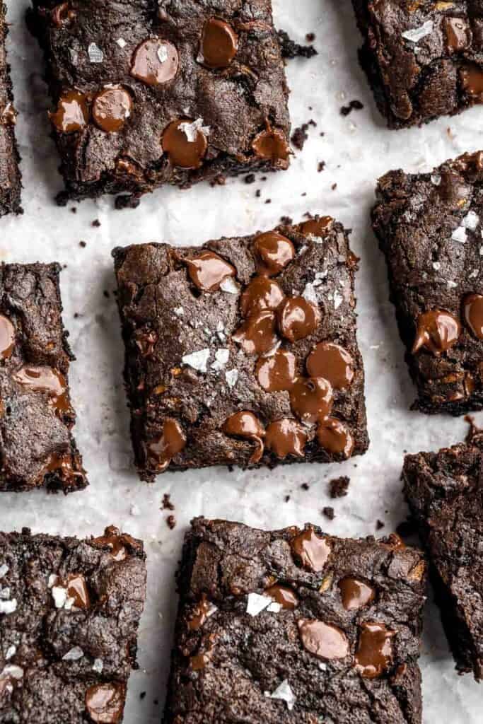 Close-up overhead view of fudgy zucchini brownie squares showing a rich, fudgy texture