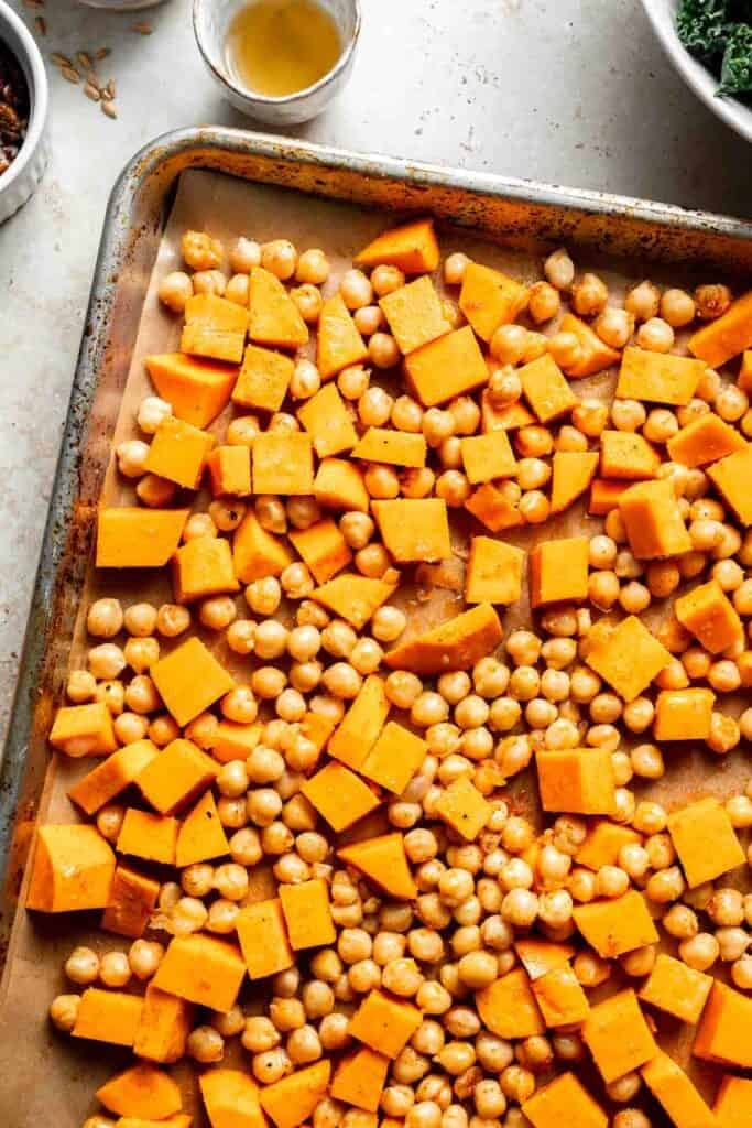 Sweet potatoes and chickpeas on a baking sheet ready for roasting