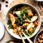 Harvest grain bowl with farro, roasted sweet potatoes, chickpeas, kale, apple, feta, and pecans in a maple Dijon dressing