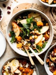 Harvest grain bowl with farro, roasted sweet potatoes, chickpeas, kale, apple, feta, and pecans in a maple Dijon dressing