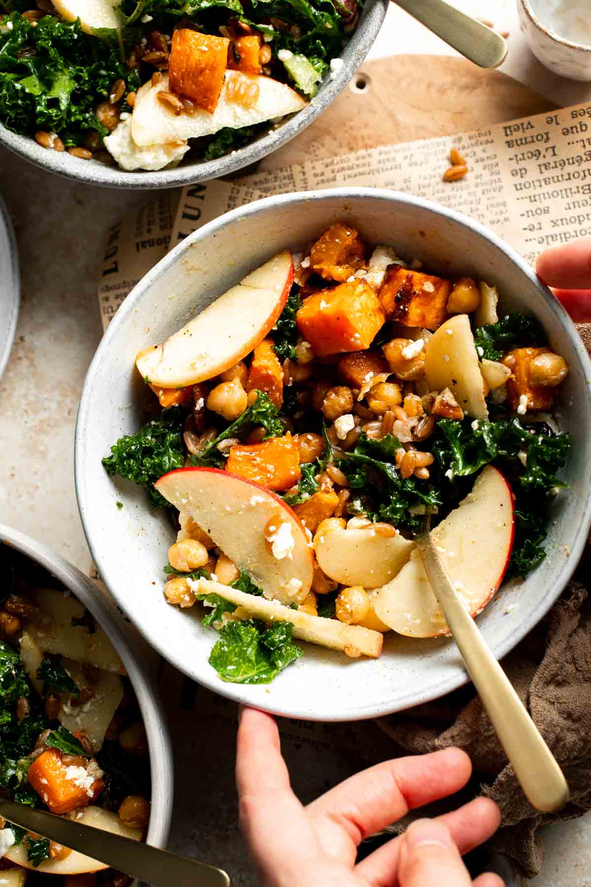 A harvest grain bowl with a fork resting inside, ready to eat