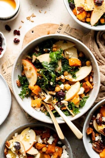 Harvest grain bowl with farro, roasted sweet potatoes, chickpeas, kale, apple, feta, and pecans in a maple Dijon dressing