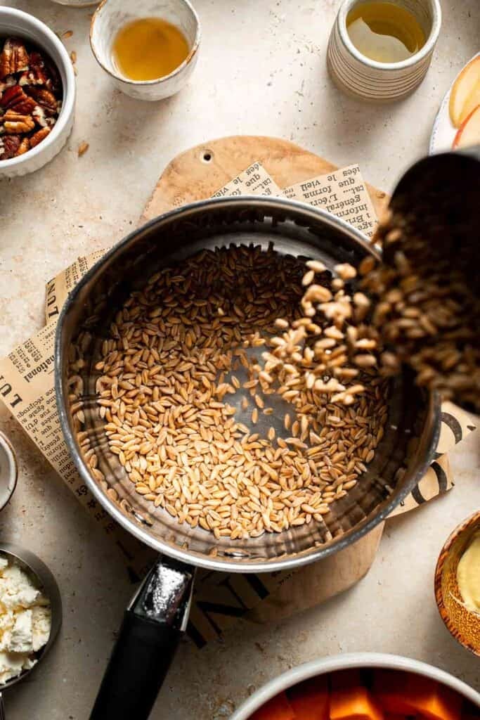 Farro being added into a saucepan