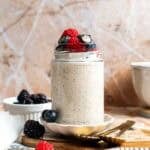 High protein overnight oats topped with berries and a drizzle of honey