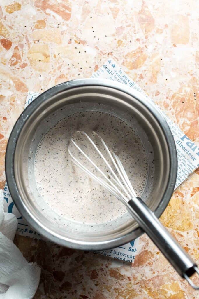 Oats and chia seeds being whisked into the yogurt mixture