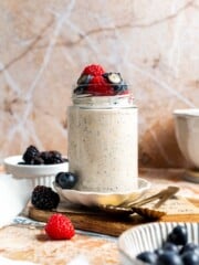 High protein overnight oats topped with berries and a drizzle of honey