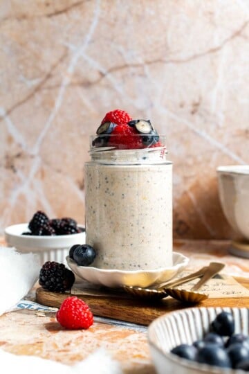 High protein overnight oats topped with berries and a drizzle of honey