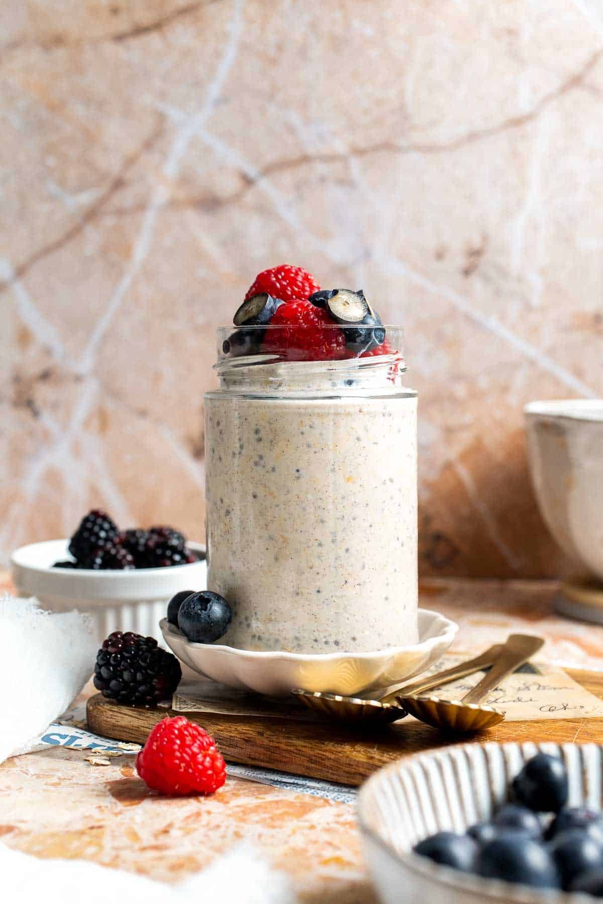 High protein overnight oats topped with berries and a drizzle of honey