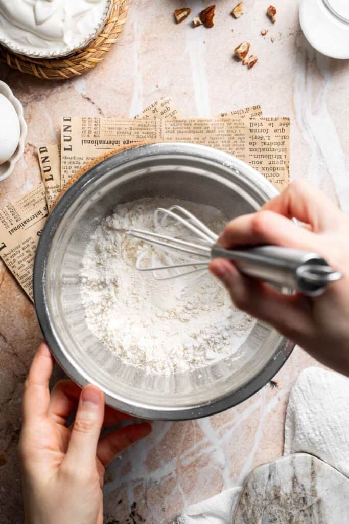 Dry ingredients being whisked together in a metal bowl