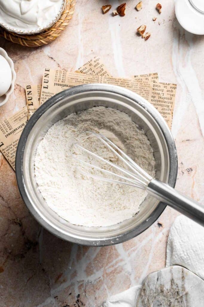 Whisked dry ingredients in a metal mixing bowl