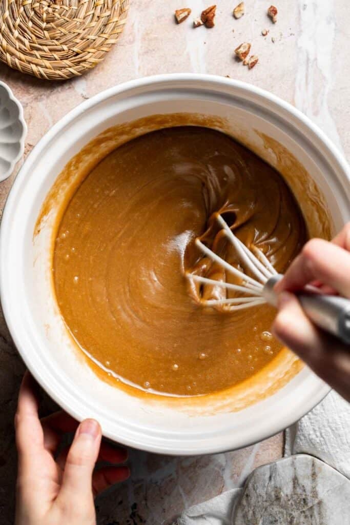 Wet ingredients being whisked together in a bowl