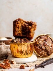 A stack of pecan pie muffins on a plate, one muffin broken in half