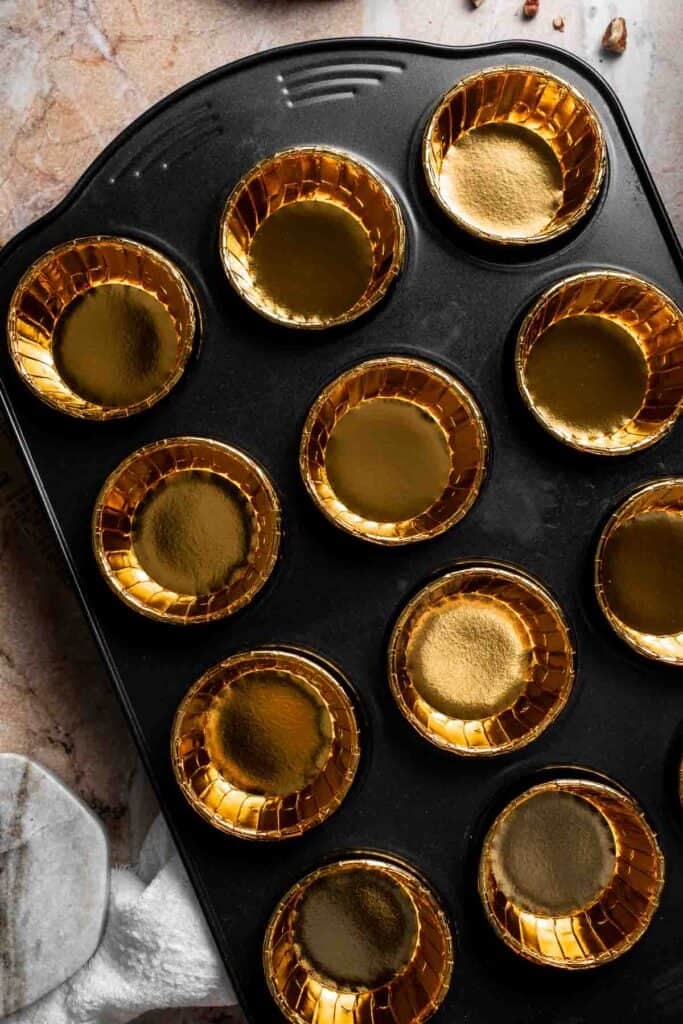 Empty muffin liners in a muffin pan before filling