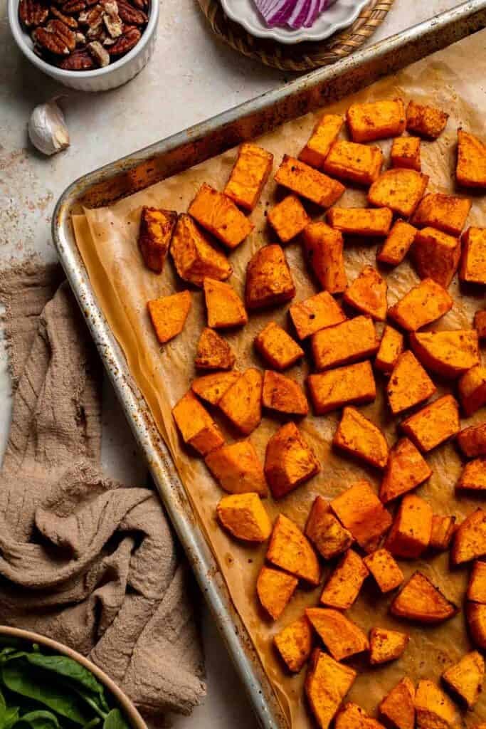 Roasted sweet potatoes on a baking sheet, tender and lightly browned