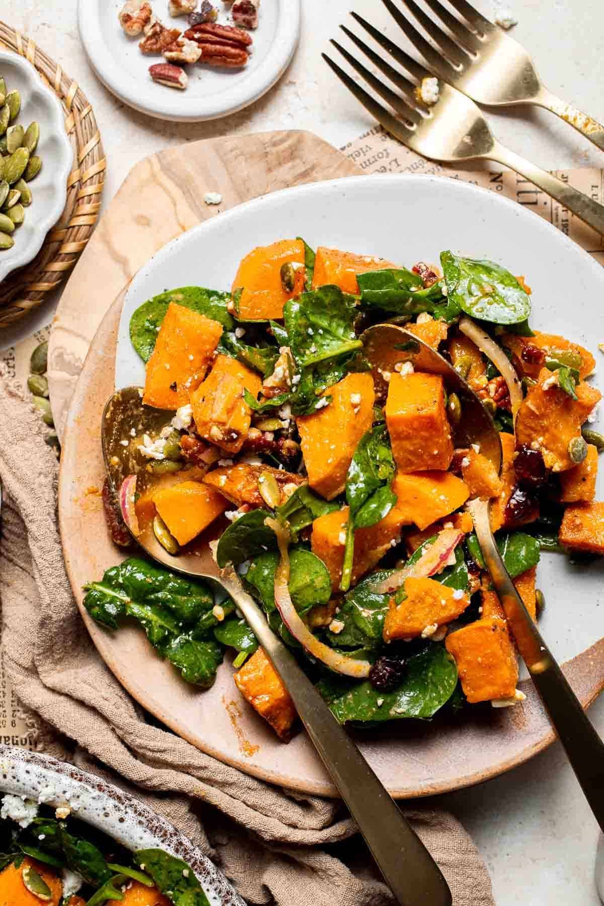 A plated serving of roasted sweet potato salad with a fork