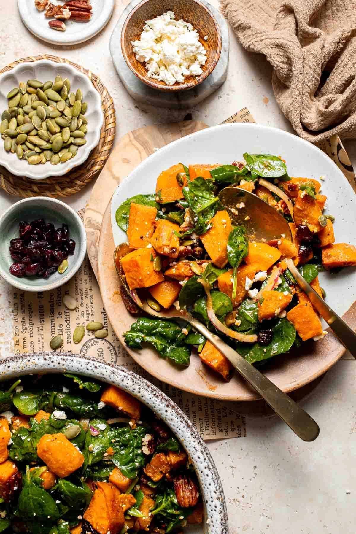 Overhead view of two plated servings of roasted sweet potato salad