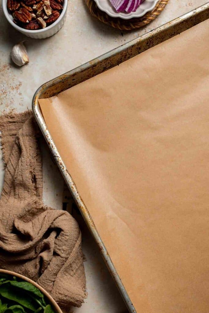 Empty parchment-lined baking sheet ready for sweet potatoes