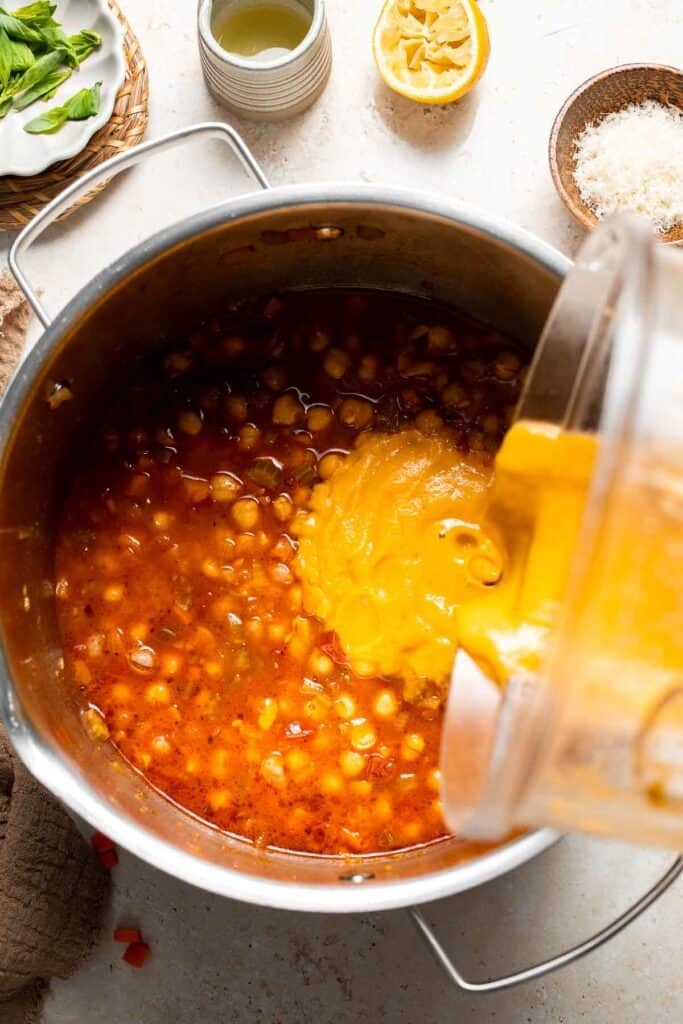Blended soup being poured back into the pot