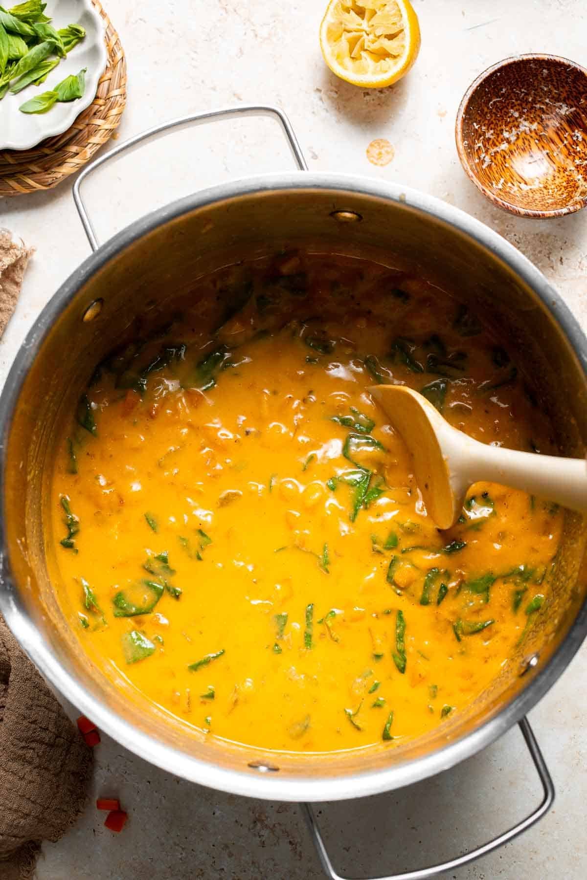 Finished Tuscan chickpea soup being stirred in a pot