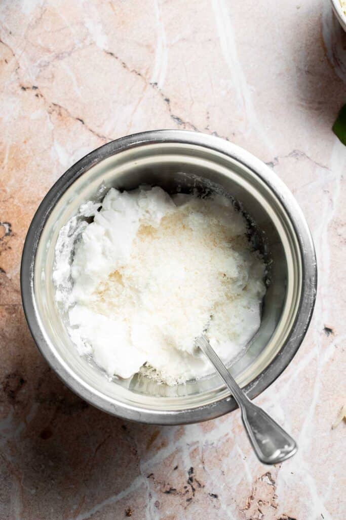 Ricotta and Parmesan cheese in a bowl before mixing