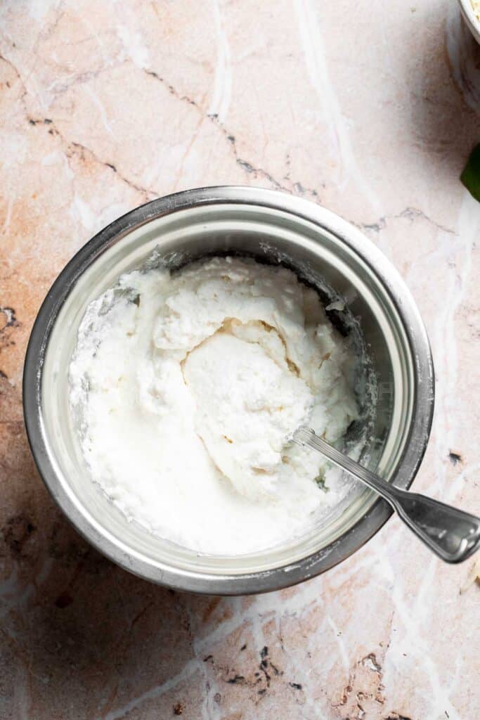 Ricotta and Parmesan cheese mixed together in a bowl