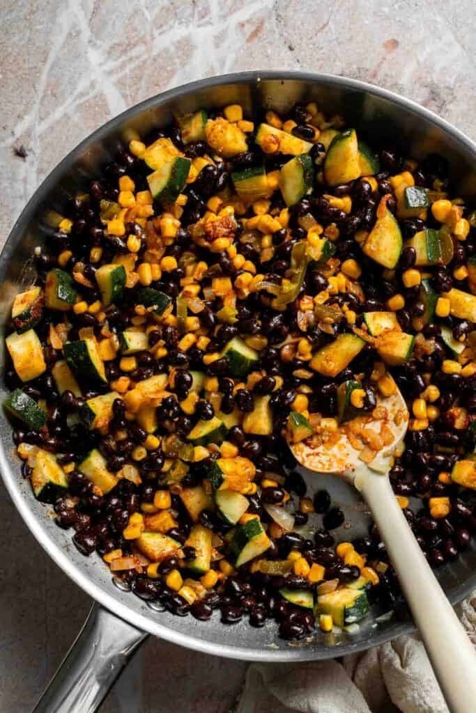 Vegetable and black bean filling cooking in a skillet