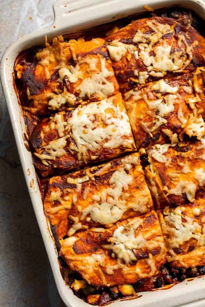 Overhead view of vegetarian enchilada casserole cut into portions